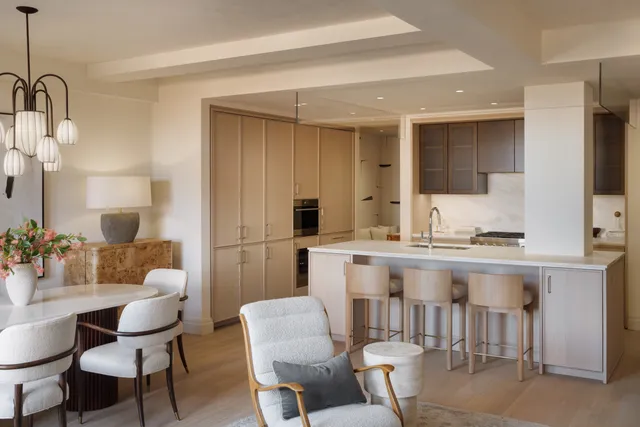 a kitchen with a table chairs sink and refrigerator