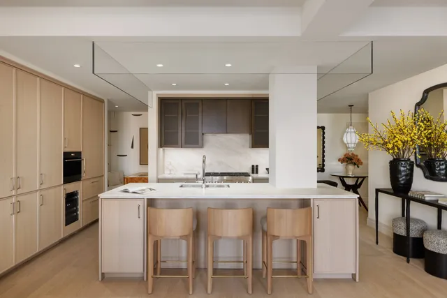 a kitchen with kitchen island granite countertop a table and chairs in it