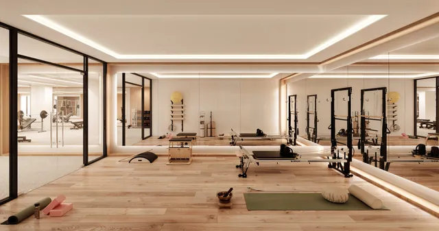 a room with gym equipment and large windows