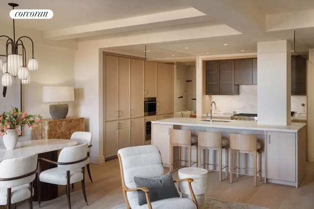 a dining room with furniture a chandelier and wooden floor