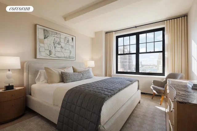 a bedroom with a bed and a painting on the wall