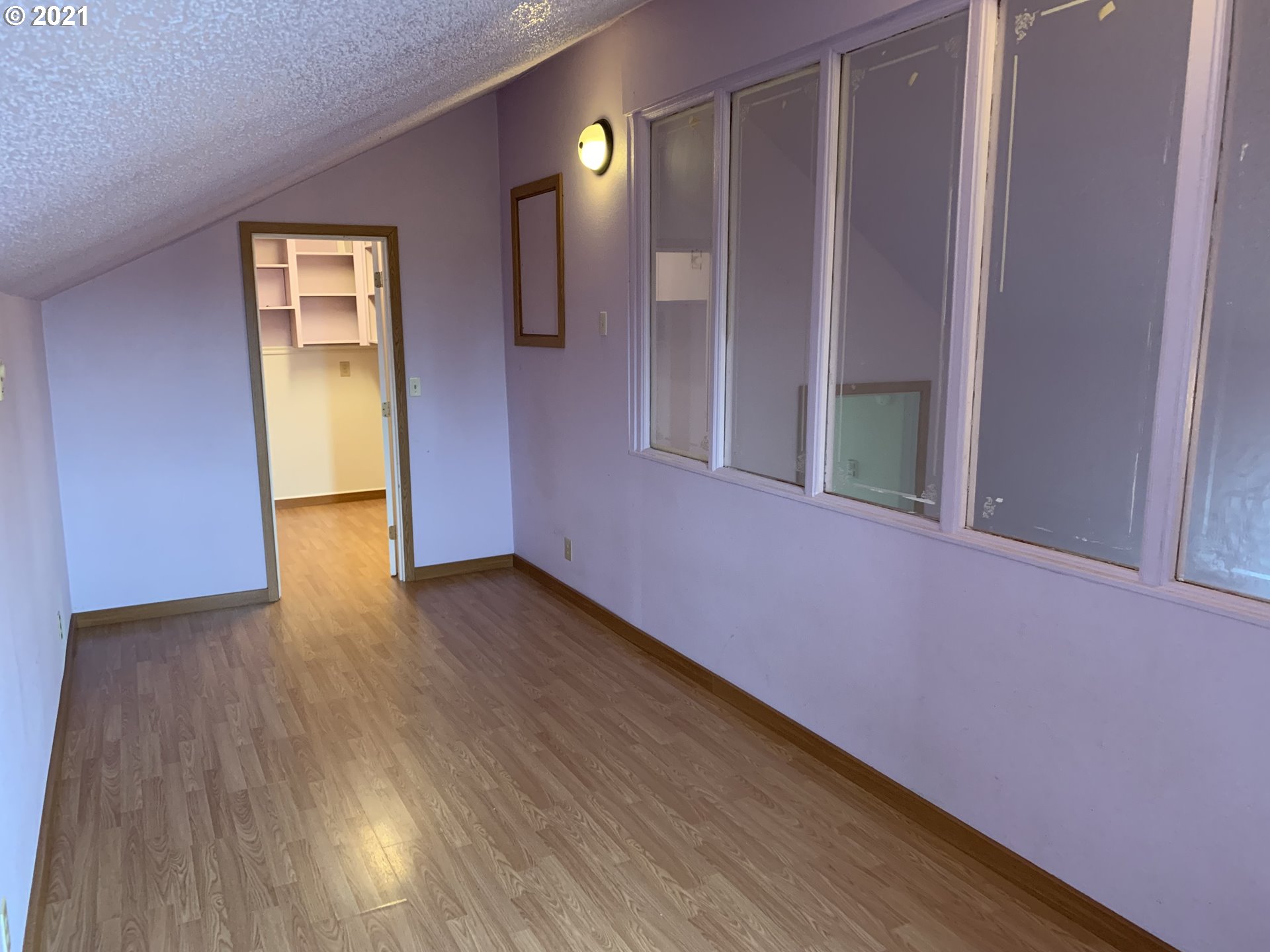410 Southwest Mill Street Sheridan, OR 97378 - Photo 13 of 25 a view of an empty room with wooden floor and a window