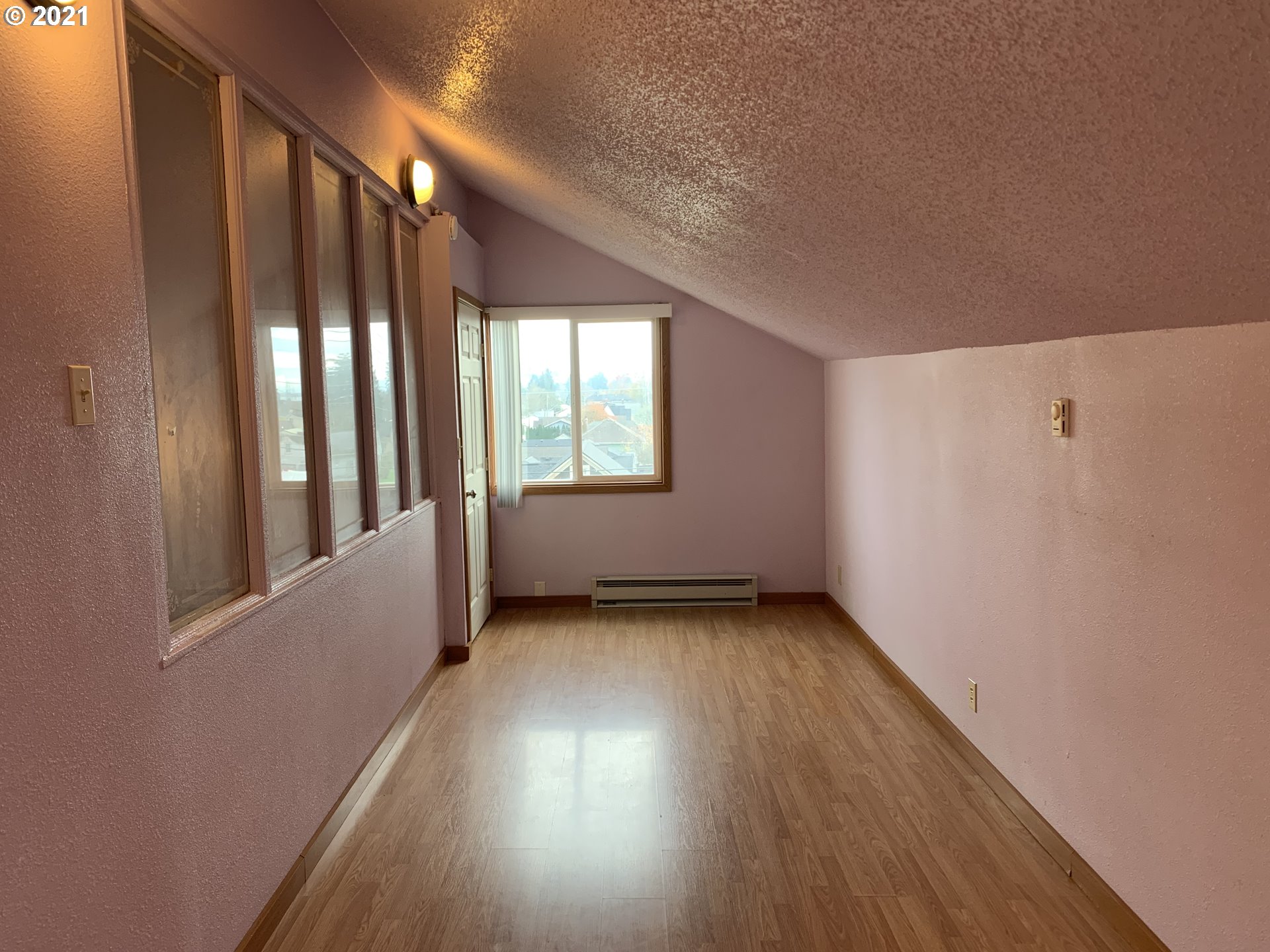 410 Southwest Mill Street Sheridan, OR 97378 - Photo 14 of 25 an empty room with wooden floor and windows
