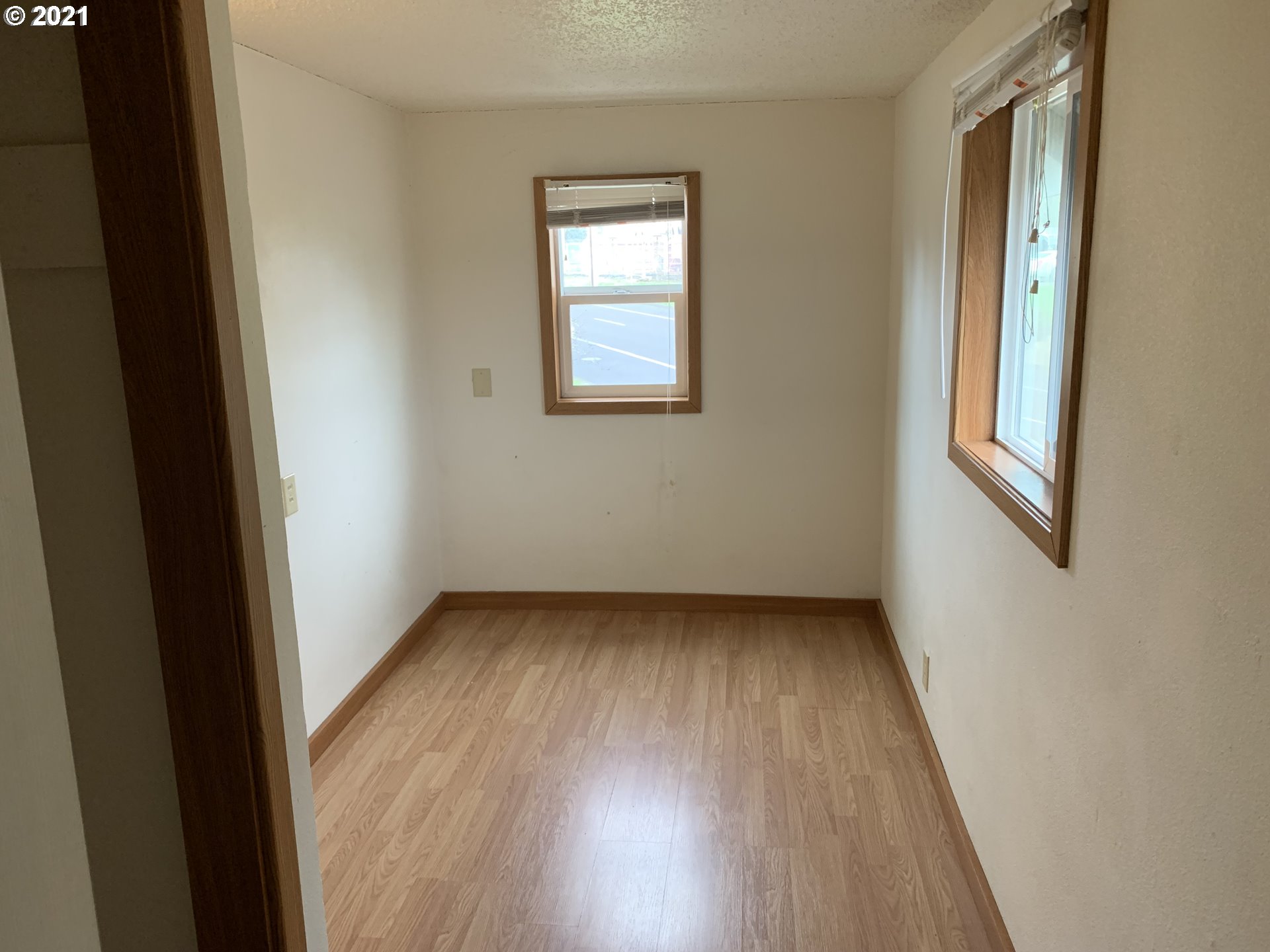 410 Southwest Mill Street Sheridan, OR 97378 - Photo 18 of 25 an empty room with wooden floor and windows