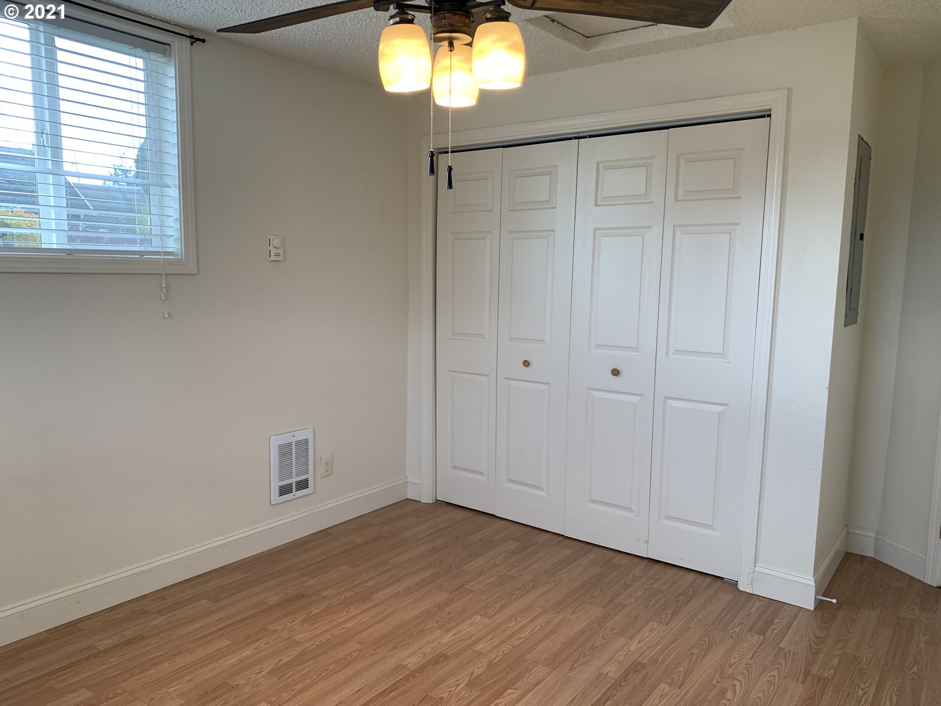 410 Southwest Mill Street Sheridan, OR 97378 - Photo 21 of 25 a view of an empty room with wooden floor and a window