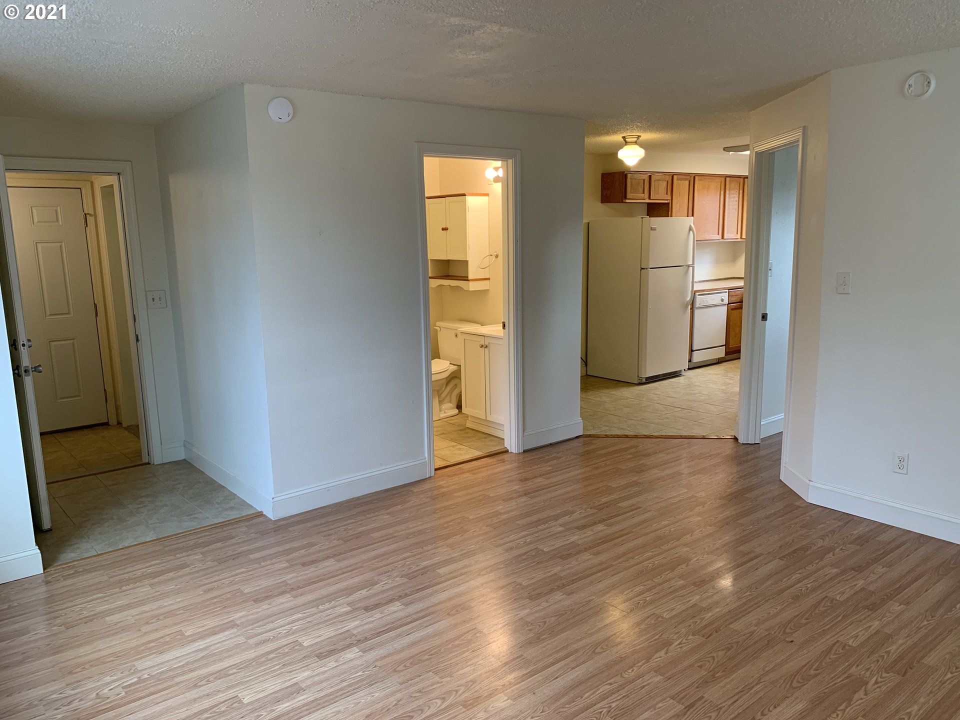 410 Southwest Mill Street Sheridan, OR 97378 - Photo 23 of 25 a view of empty room with wooden floor and kitchen