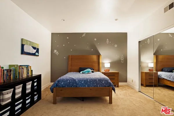 a bedroom with a bed and a night stand