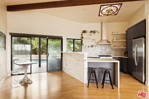 a living room with furniture wooden floor and a large window