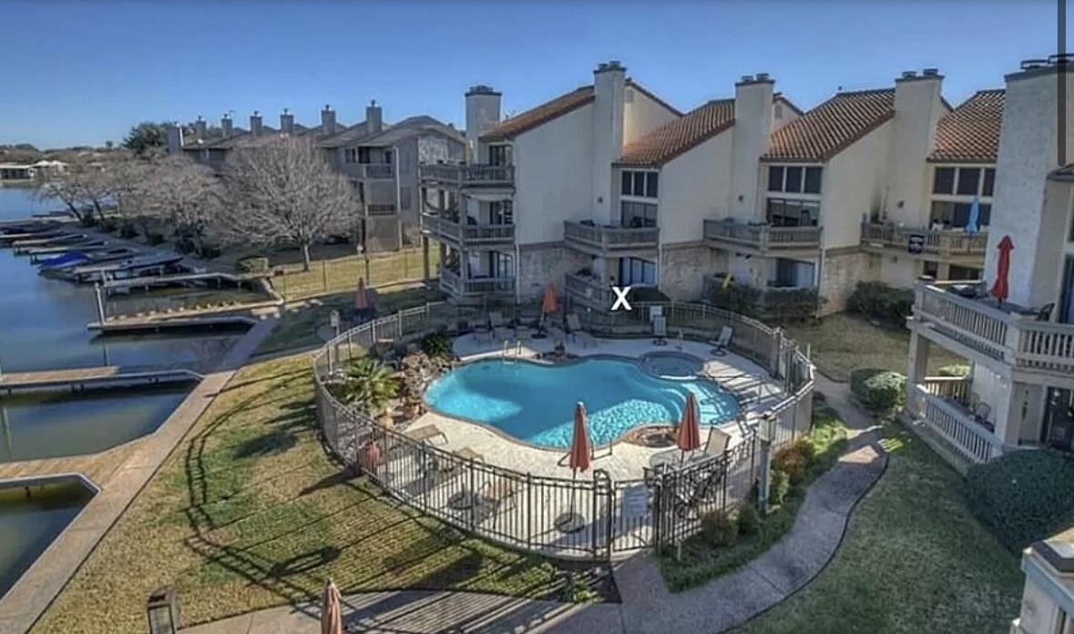 509 Short Circuit, Unit 102 Horseshoe Bay, TX 78657 - Photo 1 of 15 a swimming pool with outdoor seating and yard