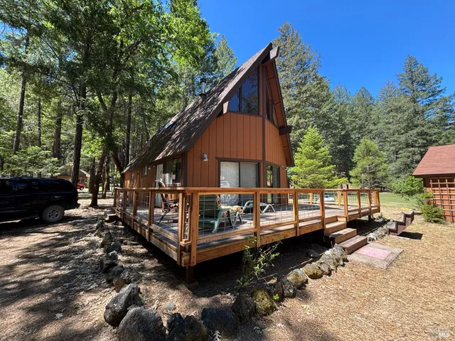 a view of a house with a yard and sitting area