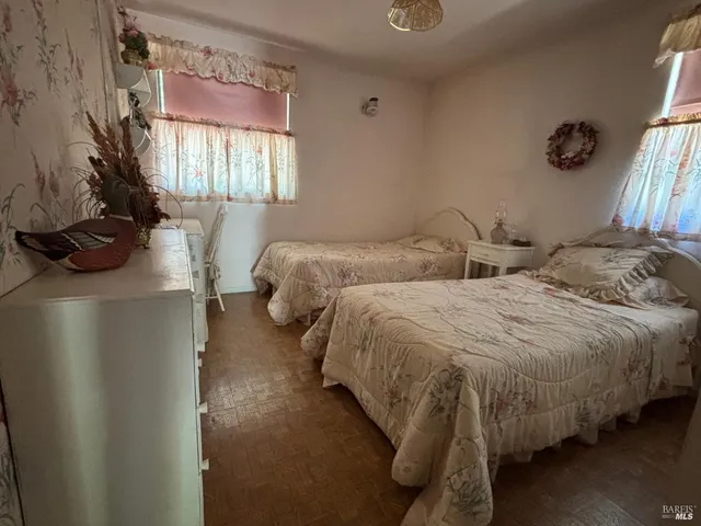 a bedroom with two beds and a couch