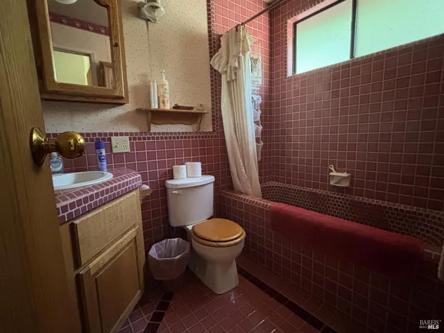 a white toilet sitting next to a bathroom sink