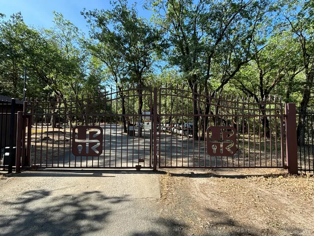 a view of a yard with wooden fence