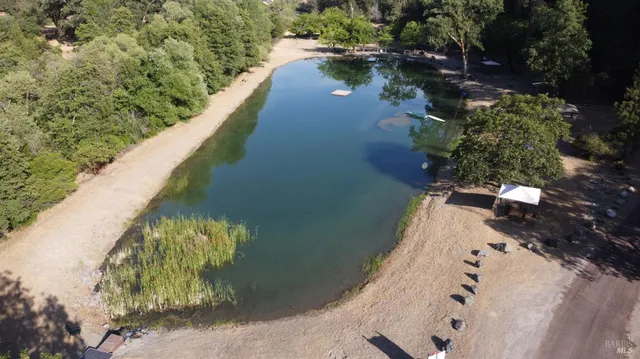 a view of a house with a yard and furniture