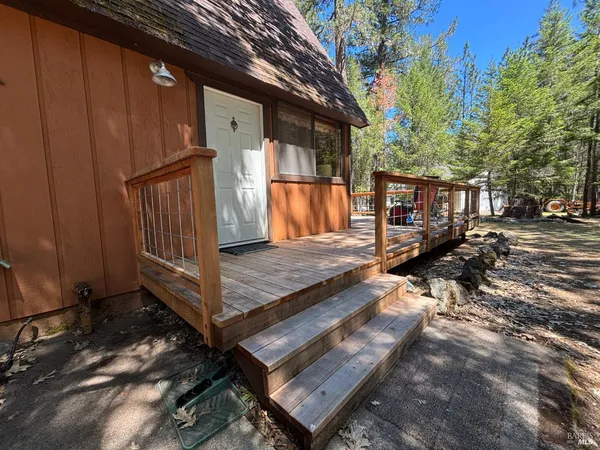 a view of backyard with wooden floor and outdoor seating