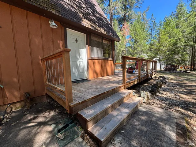 a view of backyard with wooden floor and outdoor seating