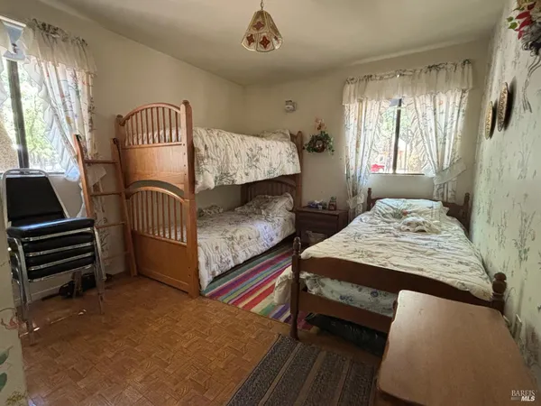 a bedroom with two beds and a window