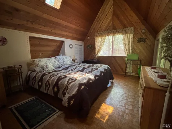 a bed sitting in a bedroom next to a window