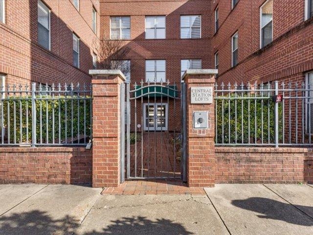 580 South Main Street, Unit 204 Memphis, TN 38103 - Photo 2 of 28 View of exterior entry featuring brick siding and a gate