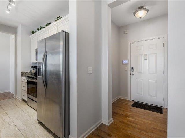 580 South Main Street, Unit 204 Memphis, TN 38103 - Photo 7 of 28 Kitchen with stainless steel appliances, white cabinetry, and light wood-type flooring