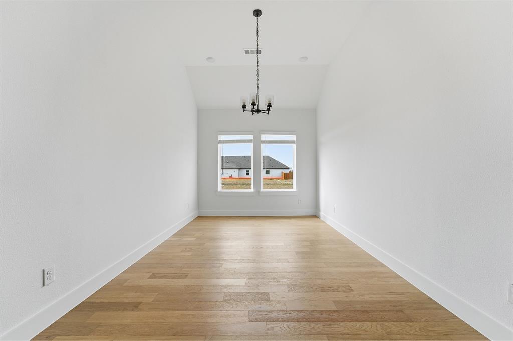 225 Charismatic Road Waxahachie, TX 75165 - Photo 11 of 21 a view of a room with a window and wooden floor