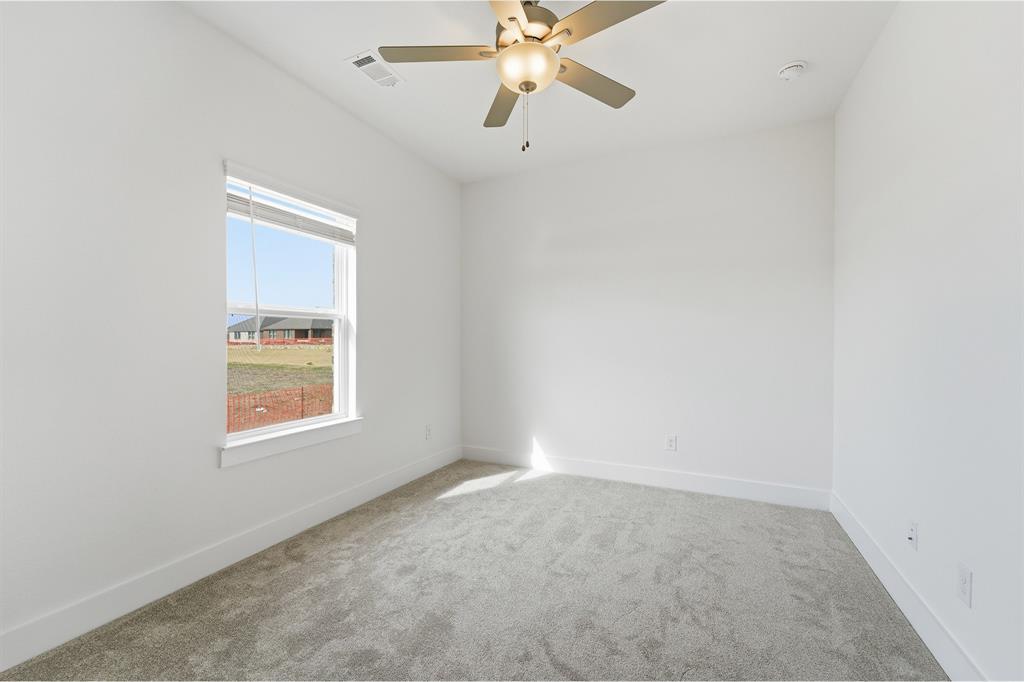 225 Charismatic Road Waxahachie, TX 75165 - Photo 18 of 21 an empty room with a window and a fan
