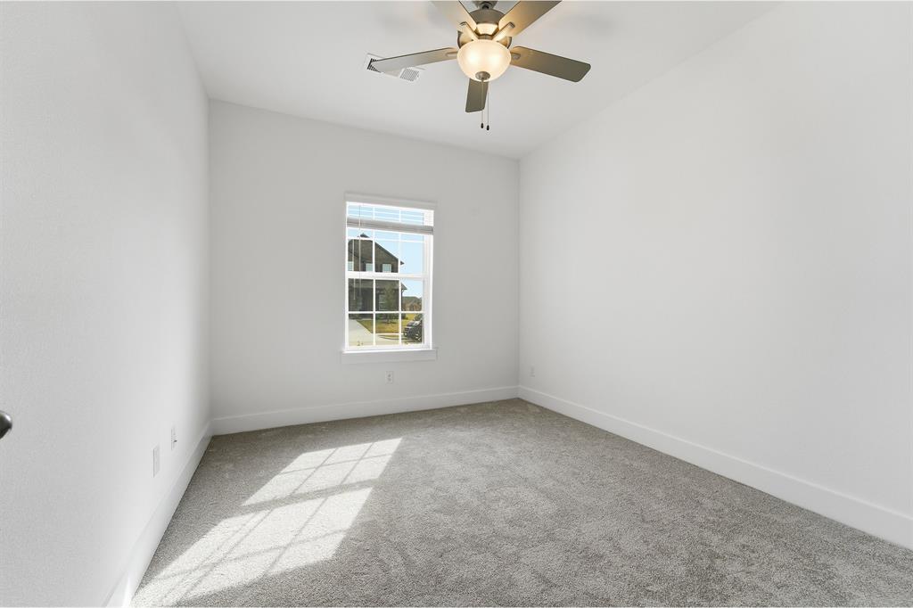 225 Charismatic Road Waxahachie, TX 75165 - Photo 19 of 21 an empty room with a window and a fan