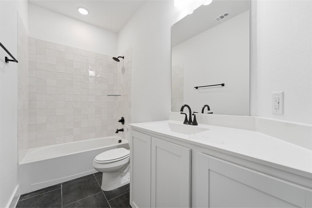225 Charismatic Road Waxahachie, TX 75165 - Photo 20 of 21 a bathroom with a sink a toilet and a bathtub