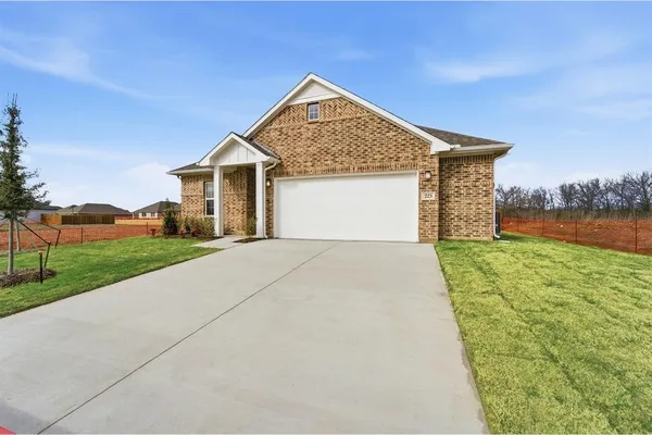 a front view of house with yard and green space