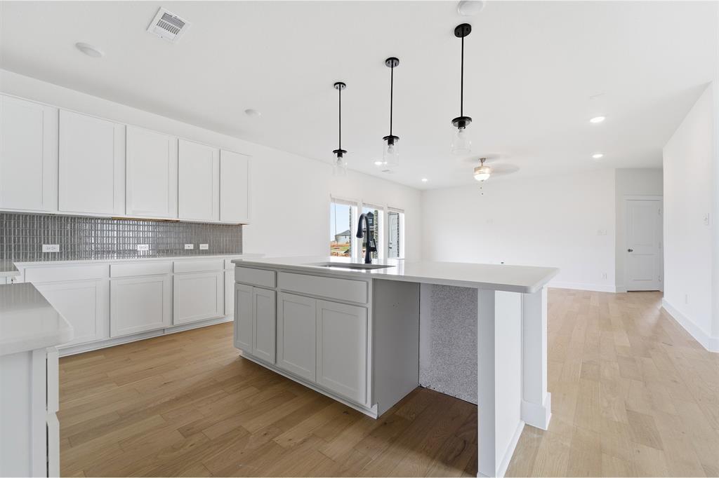 225 Charismatic Road Waxahachie, TX 75165 - Photo 5 of 21 a kitchen with white cabinets and white appliances