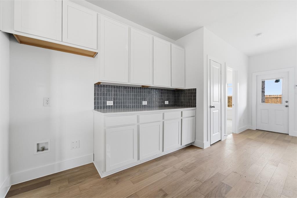 225 Charismatic Road Waxahachie, TX 75165 - Photo 8 of 21 a view of cabinets with wooden floor