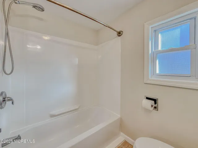 a bathroom with a shower and a toilet sink