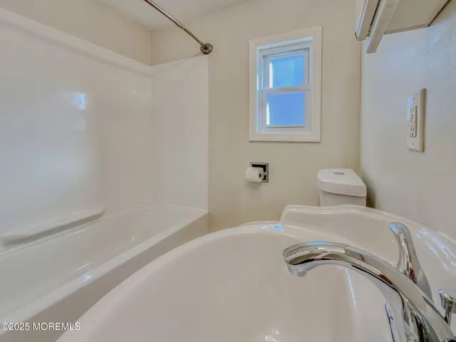 a bathroom with a tub and a shower