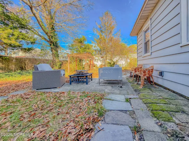 a view of a backyard with sitting area
