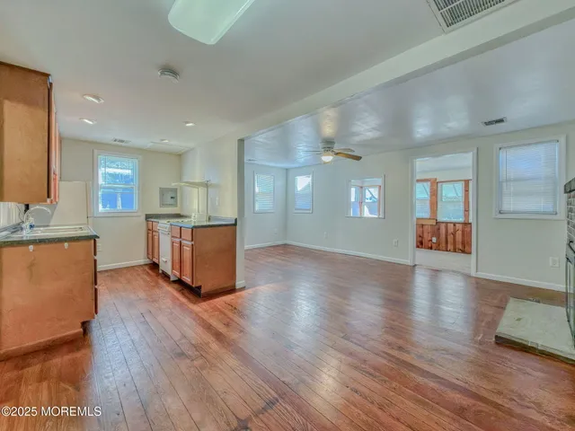 a living room with hard wood floors and furniture or kitchen