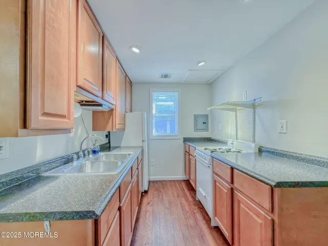 a kitchen with a sink stove and cabinets