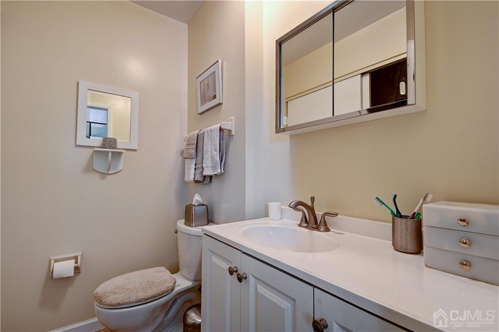 30 Pebble Road East Windsor, NJ 08520 - Photo 11 of 15 a bathroom with a sink a toilet and mirror