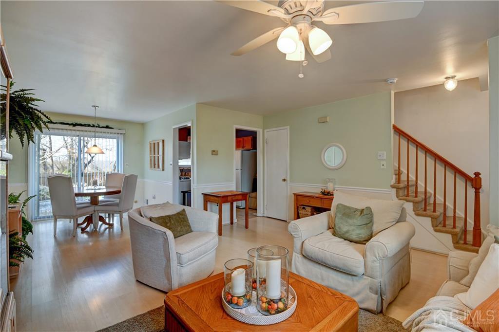 30 Pebble Road East Windsor, NJ 08520 - Photo 4 of 15 a living room with furniture a chandelier and a flat screen tv