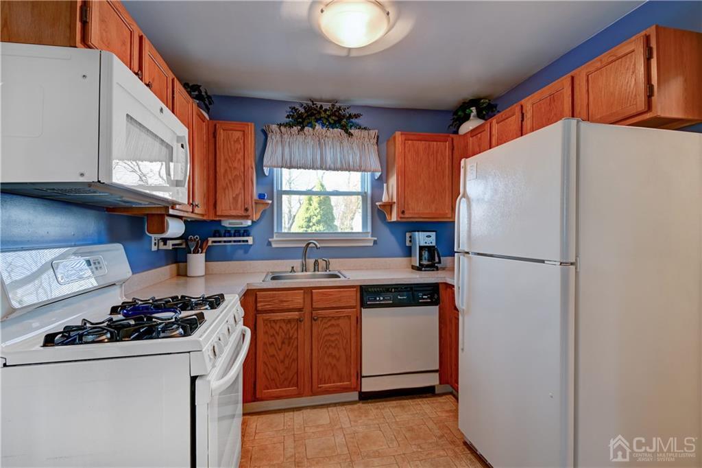 30 Pebble Road East Windsor, NJ 08520 - Photo 7 of 15 a kitchen with a refrigerator a stove a sink and cabinets