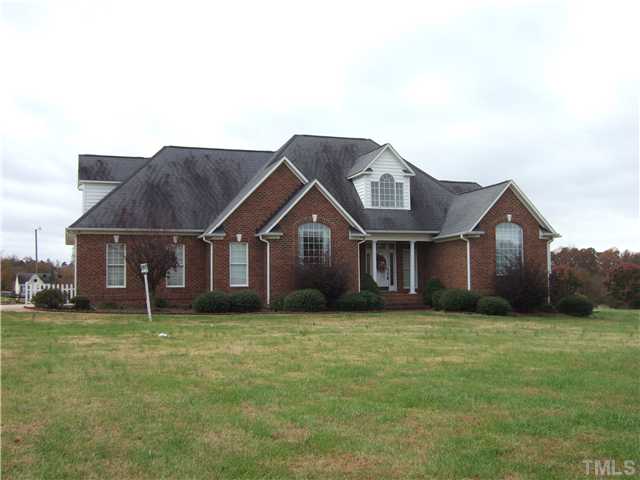 722 Blackard Road Roxboro, NC 27574 - Photo 1 of 22 a house that is sitting in the grass with large trees