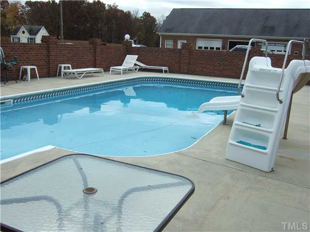 722 Blackard Road Roxboro, NC 27574 - Photo 17 of 22 a view of a swimming pool with a lawn chairs