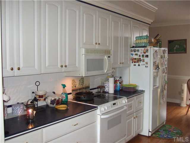 722 Blackard Road Roxboro, NC 27574 - Photo 4 of 22 a kitchen with refrigerator and cabinets