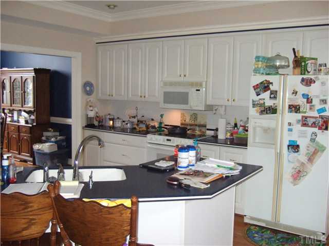 722 Blackard Road Roxboro, NC 27574 - Photo 5 of 22 a kitchen with granite countertop a sink a stove and a table in it