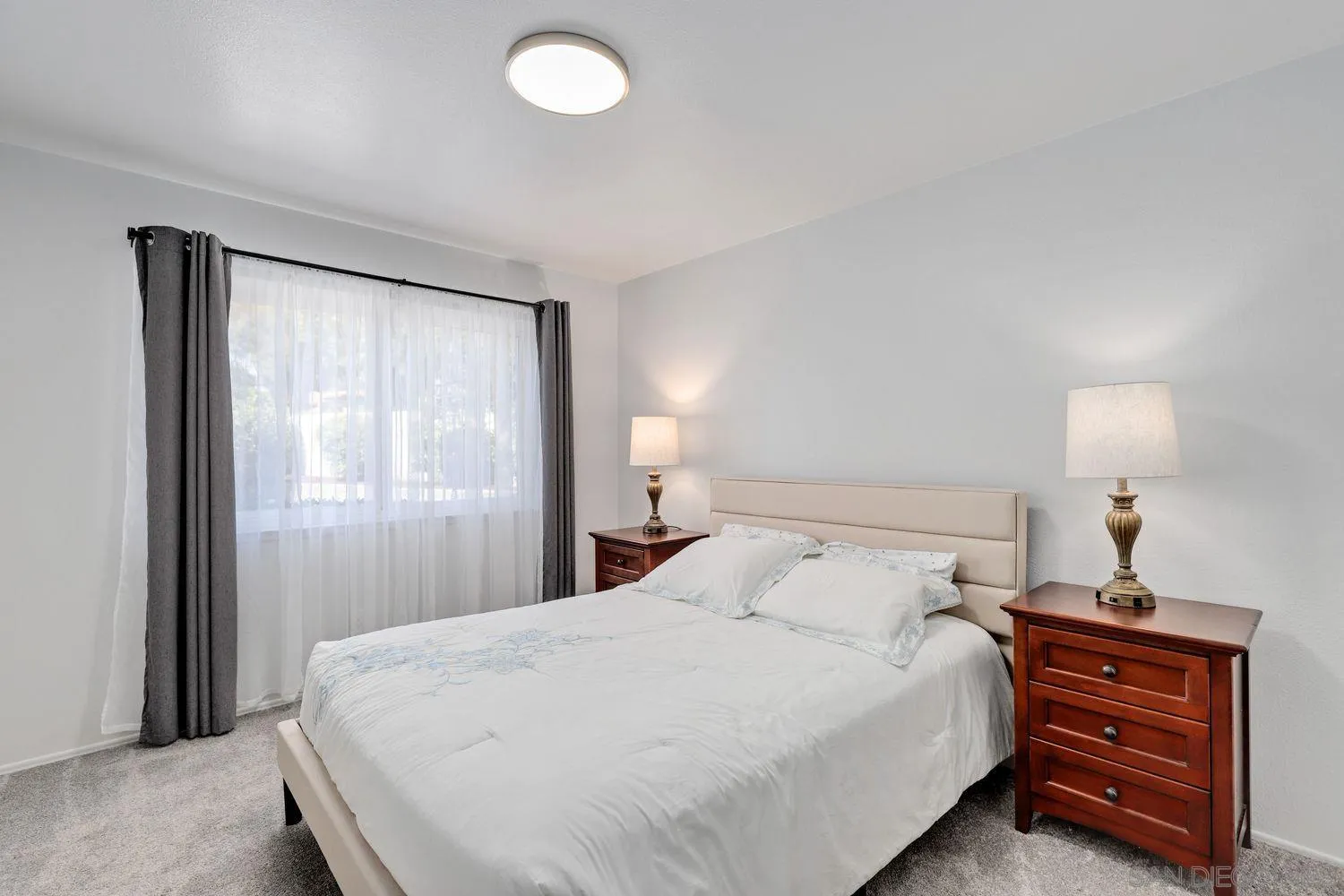 12496 Bodega Road San Diego, CA 92128 - Photo 13 of 44 a bedroom with a bed and a lamp