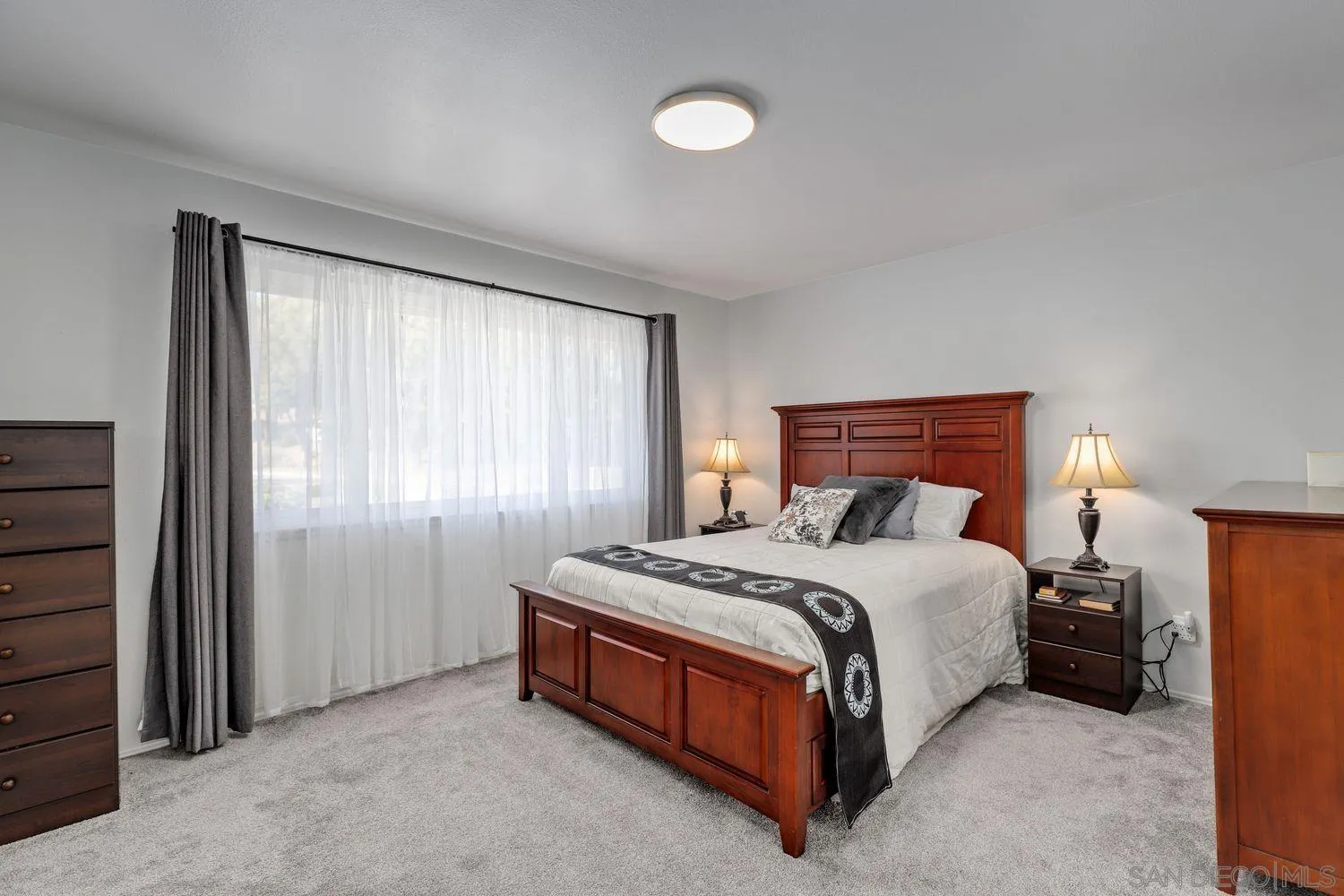 12496 Bodega Road San Diego, CA 92128 - Photo 16 of 44 a bedroom with a bed lamp and window