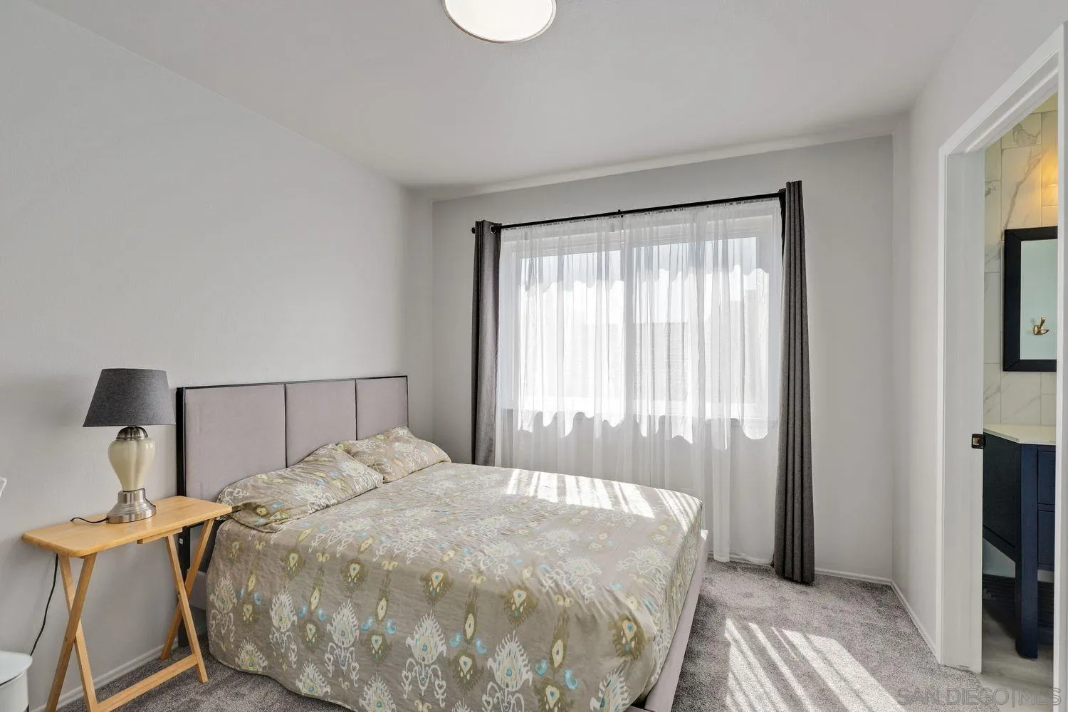 12496 Bodega Road San Diego, CA 92128 - Photo 25 of 44 a bed sitting in a bedroom next to a window