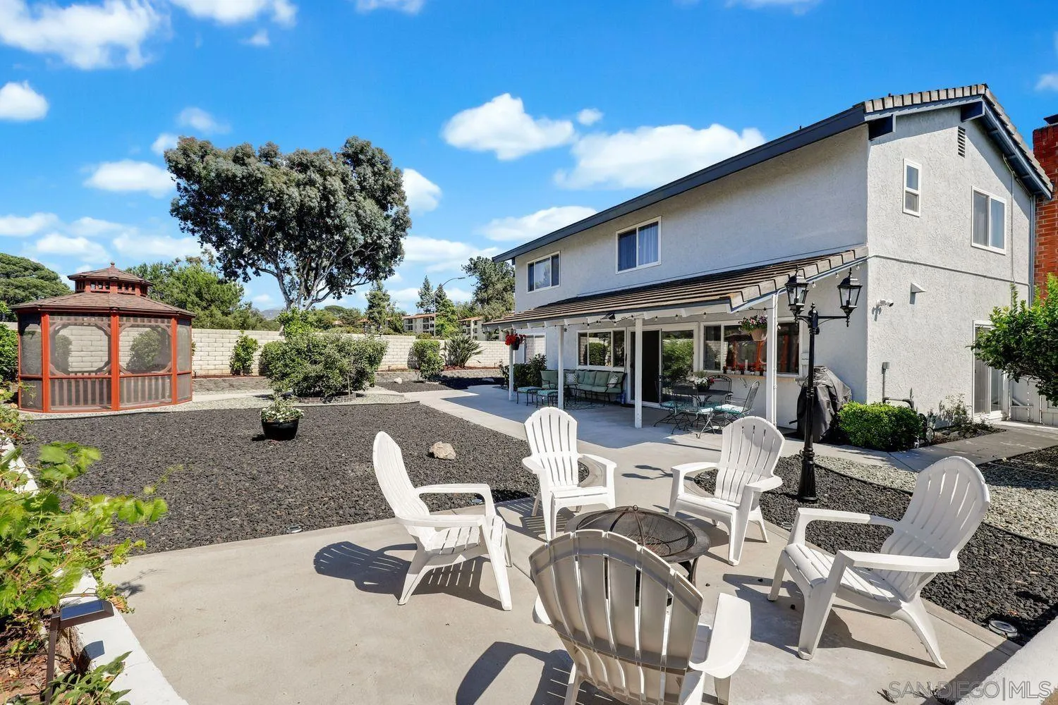 12496 Bodega Road San Diego, CA 92128 - Photo 29 of 44 a view of a patio with couches table and chairs and potted plants