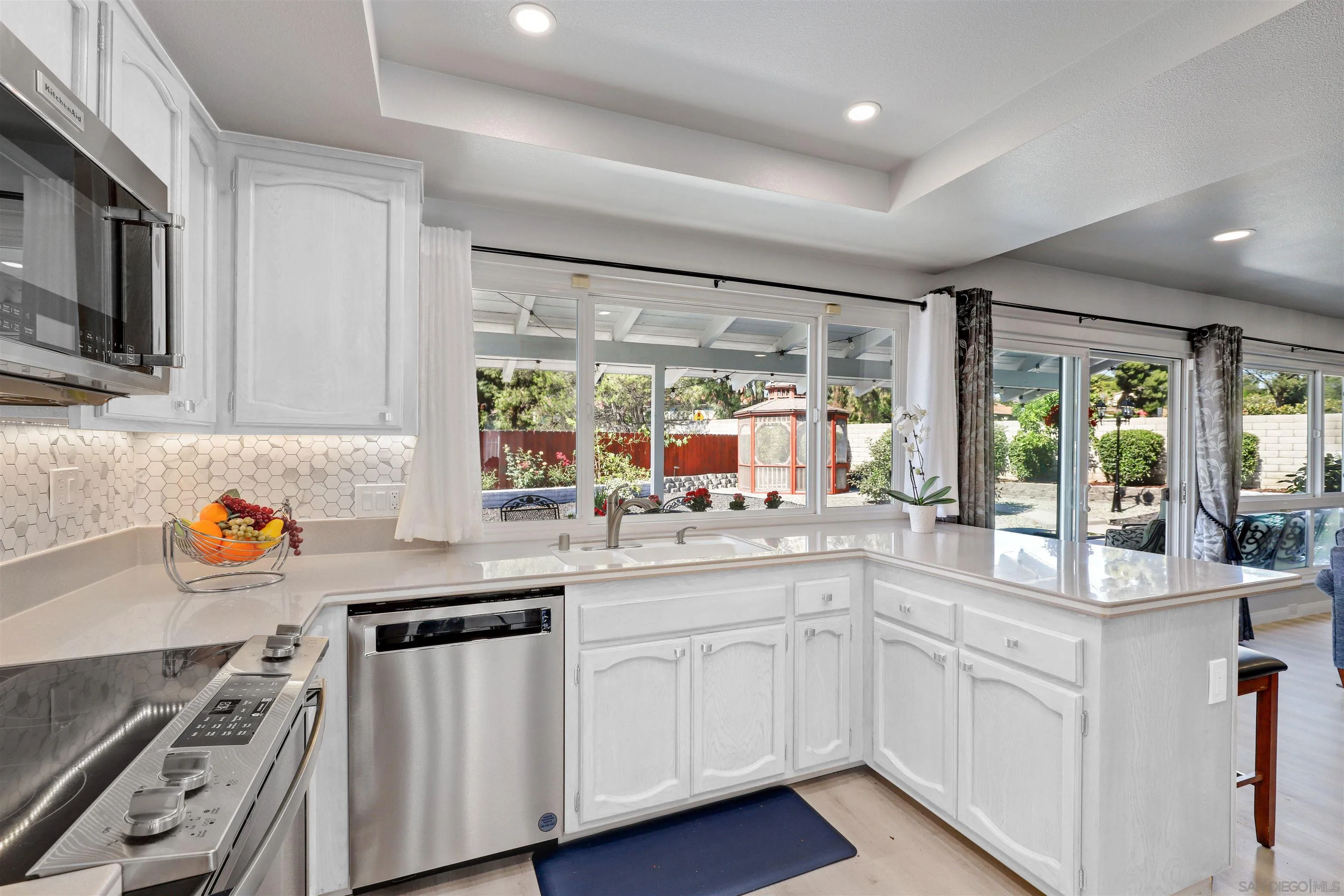 12496 Bodega Road San Diego, CA 92128 - Photo 7 of 44 a kitchen with sink a stove and microwave
