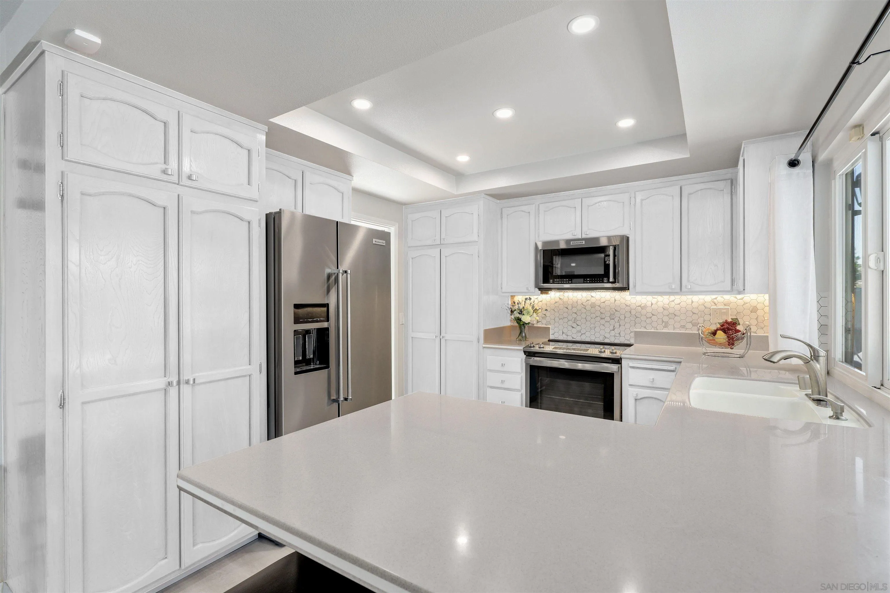 12496 Bodega Road San Diego, CA 92128 - Photo 8 of 44 a kitchen with stainless steel appliances a refrigerator sink and stove