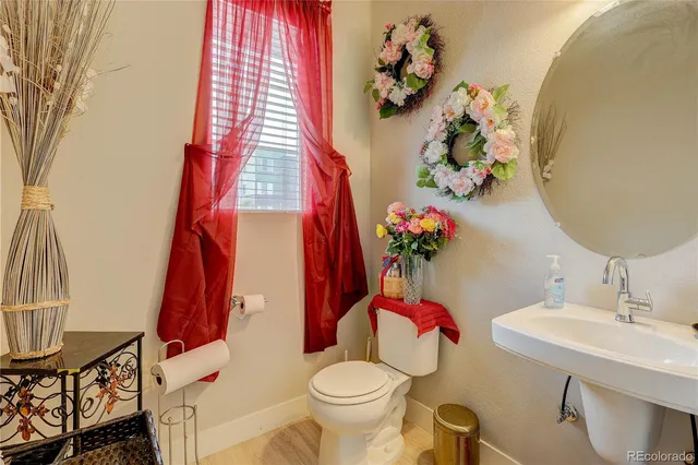 a bathroom with a sink toilet and shower curtain
